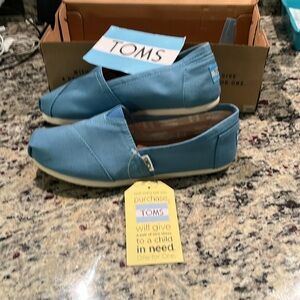Original Tom’s loafers new with tags and box size 7.5 in cornflower blue .